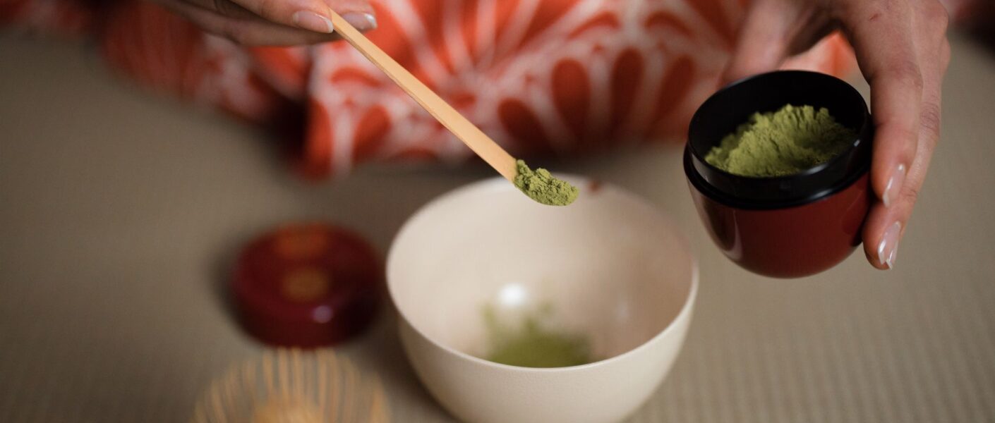 woman wearing traditional geisha kimono at tea ceremony