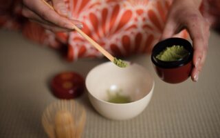 woman wearing traditional geisha kimono at tea ceremony